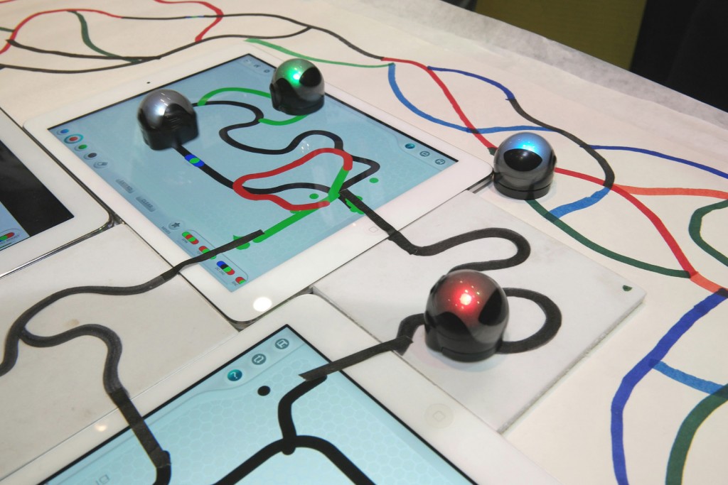 Creative technology at work with the Ozobot that let's children code the actions and directions of tiny robots on flat screens or printed paper 