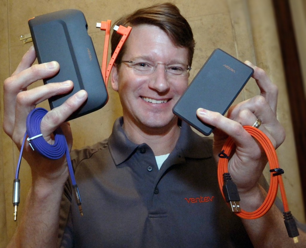 Ventev Mobile Director of Marketing Scott Franklin shows quality mobile accessories including the new  Powercell 10000+ direct wall charger-battery left, that charges three devices at the same time